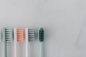 A close-up of neatly arranged toothbrushes on a marble background emphasizing dental care.