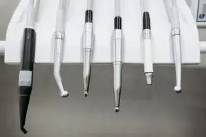 Close-up view of dental instruments organized in a holder, ready for use.